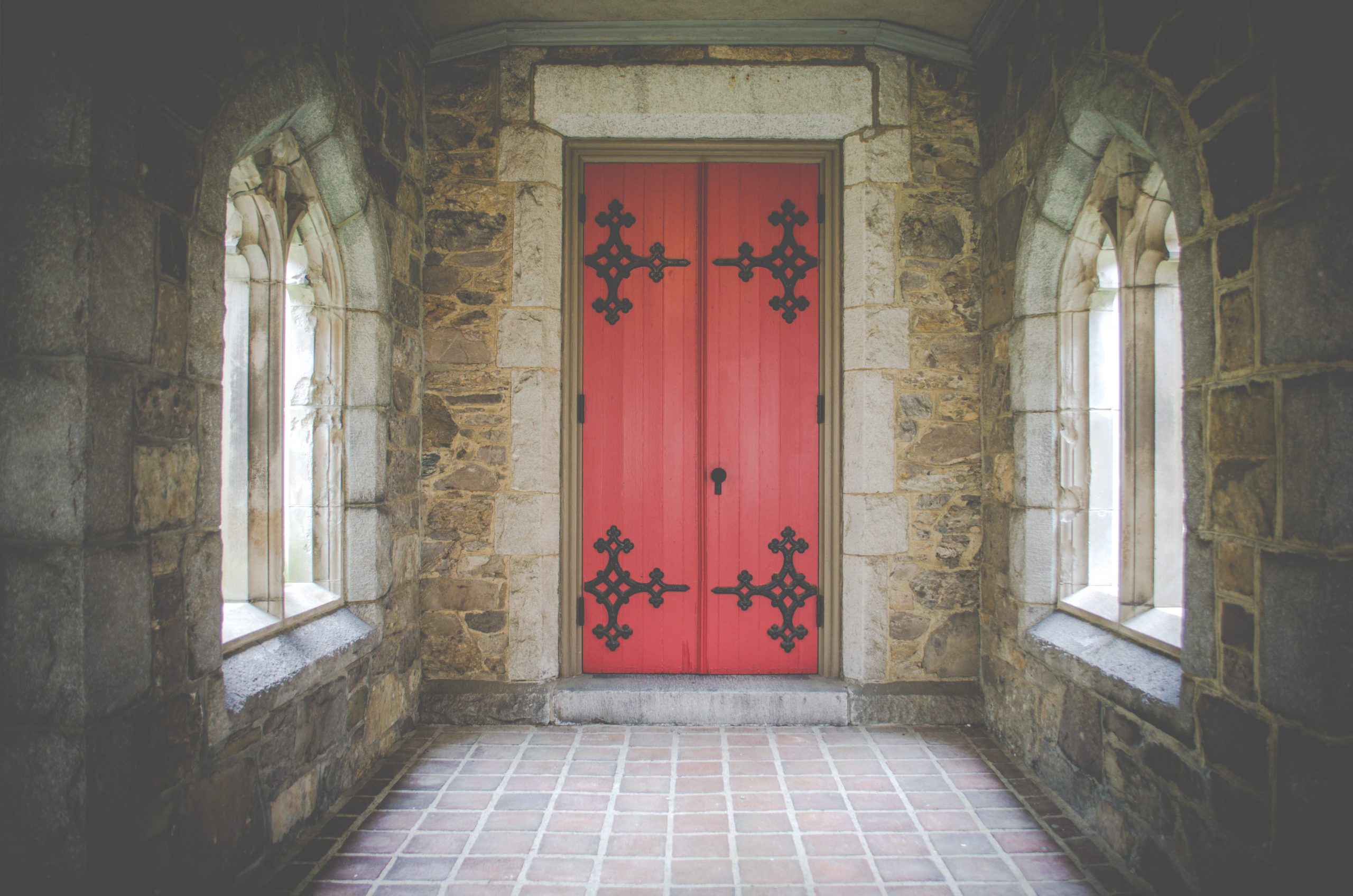the power of doors, red door in cathedral with windows