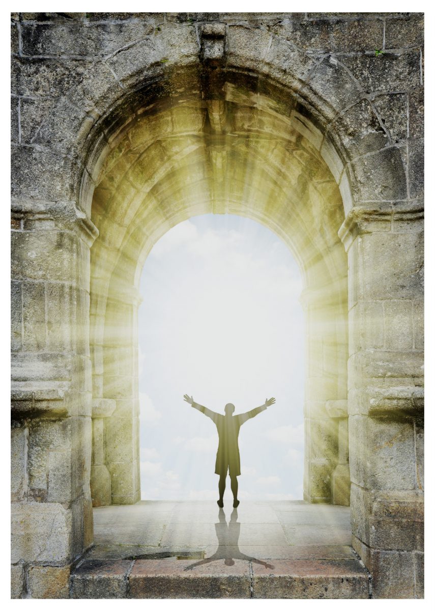 man standing in ancient gate with burst of sunlight everlasting gate