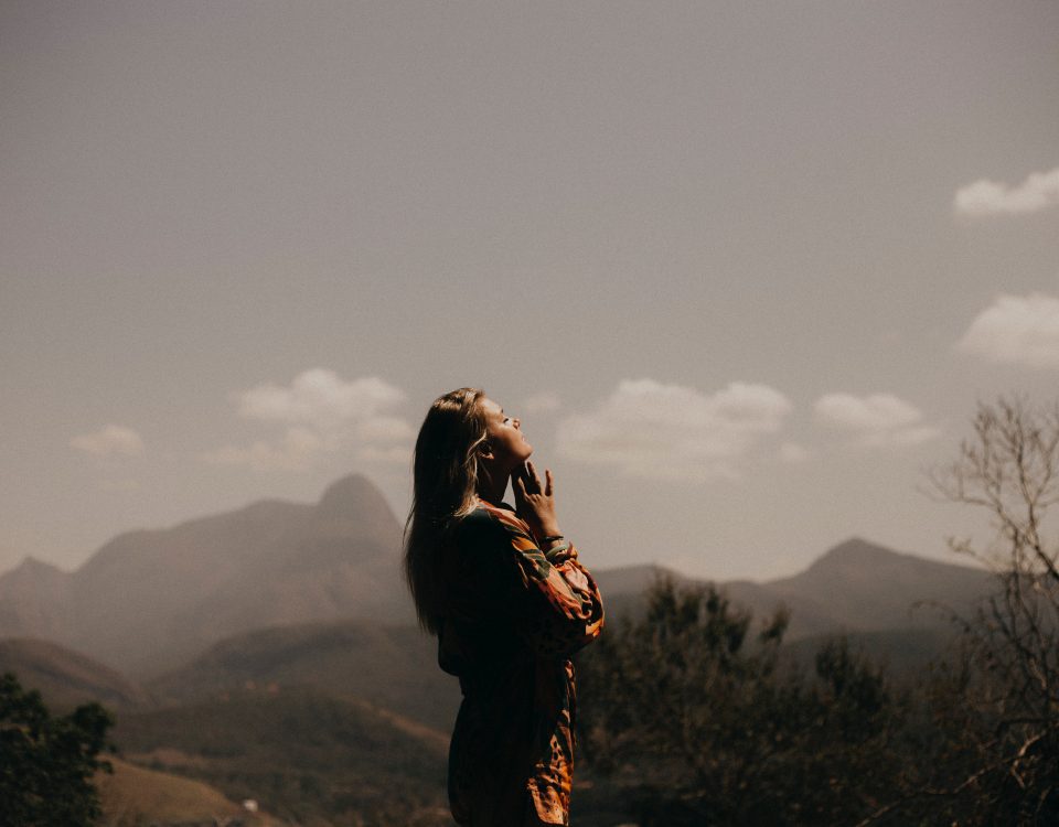 until you know you are loved, woman in the mountains looking up in gratefulness