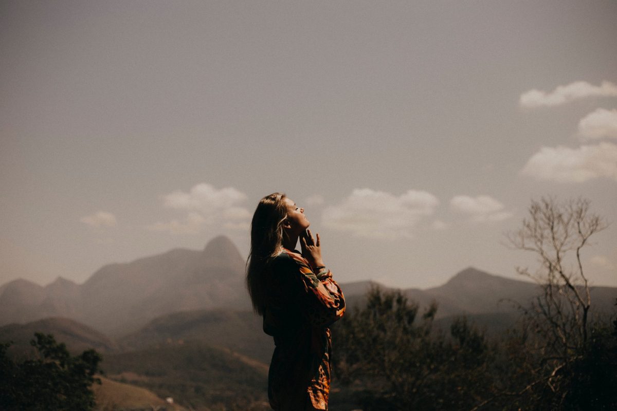 until you know you are loved, woman in the mountains looking up in gratefulness